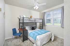 Austin apartment for rent - A bedroom with a bunk bed and a chair.