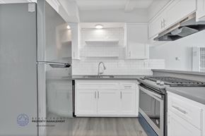 Redondo Beach apartment for rent - A modern kitchen with white cabinets and stainless steel appliances.
