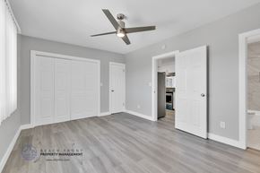Redondo Beach apartment for rent - a bedroom with two closets and a ceiling fan