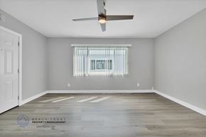Redondo Beach apartment for rent - the living room of a rental house with a window and a ceiling fan