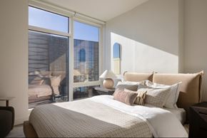 San Francisco apartment for rent - A bedroom with a large bed and a view of a balcony.
