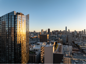 San Francisco apartment for rent - A cityscape with a large building in the foreground and smaller buildings in the background.