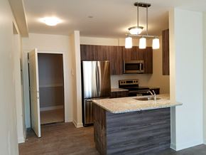 Melrose apartment for rent - a kitchen with a granite counter top and a stainless steel refrigerator