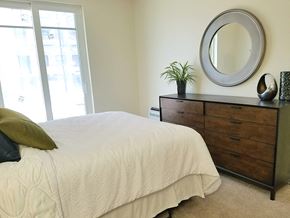 Melrose apartment for rent - a bedroom with a bed and a dresser with a mirror