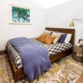 Denver apartment for rent - a bedroom with a bed with a blue blanket and pillows