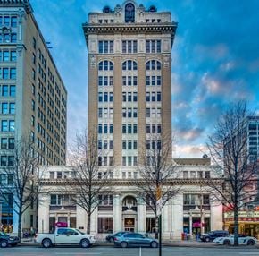 Chattanooga apartment for rent - a tall building on a city street with cars
