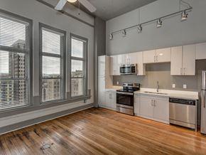 Chattanooga apartment for rent - an empty kitchen with a large window and a wood floor