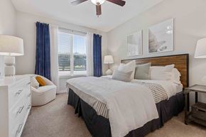 Greenville apartment for rent - a bedroom with a bed and a ceiling fan