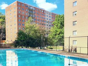 Takoma Park apartment for rent - a swimming pool with a building in the background