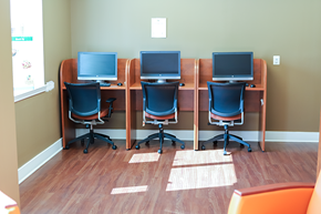 Baltimore apartment for rent - a row of computer desks with three monitors on top of them