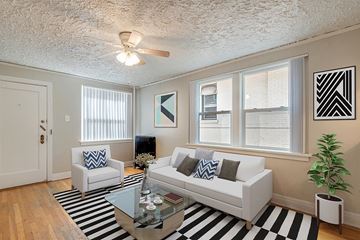 Denver apartment for rent - a living room with a white couch and a glass coffee table