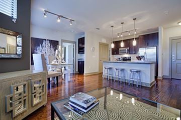 Dallas apartment for rent - A modern living room with a coffee table and a large mirror on the wall.