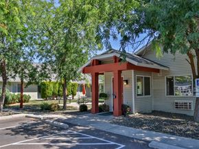 Weiser apartment for rent - the front of our office with trees and a parking lot