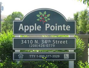 Boise apartment for rent - a sign for apple pointe in front of trees