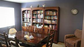 Idaho Falls apartment for rent - a dining room with a table and chairs and a bookcase