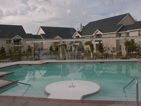 Nampa apartment for rent - a large swimming pool with a building in the background