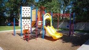 Wendell apartment for rent - a playground with a swing set and slides