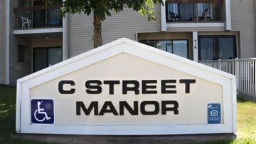 Rupert apartment for rent - a sign for c street manor in front of a building
