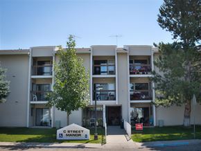 Rupert apartment for rent - the exterior of an apartment building with a street sign in front