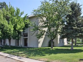 Rupert apartment for rent - an old white building with trees in front of it