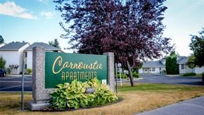 Shelley apartment for rent - a green sign sitting in front of a building
