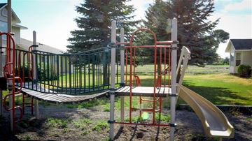 Shelley apartment for rent - a swing set and slide in a playground