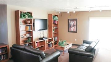 Shelley apartment for rent - a living room with leather furniture and a television