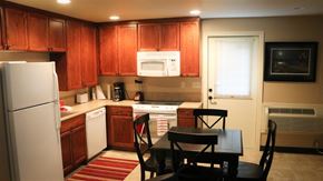 Shelley apartment for rent - a small kitchen with a table and a refrigerator