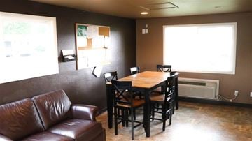 Emmett apartment for rent - a living room with a wooden table and leather furniture