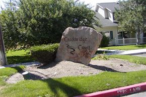 Nampa apartment for rent - a rock sitting in the grass in front of a house