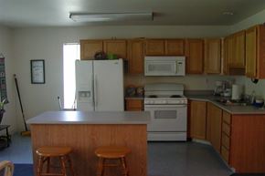 Nampa apartment for rent - a kitchen with white appliances and wooden cabinets