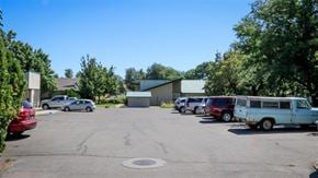 Weiser apartment for rent - a parking lot filled with cars and a building