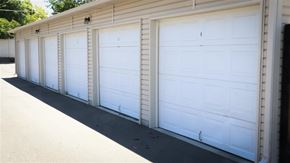 Twin Falls apartment for rent - three white garage doors on the side of a building