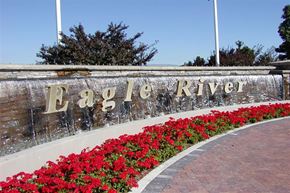 Eagle apartment for rent - a sign for echo river with flowers in front of it