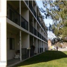 Eagle apartment for rent - an apartment building with a lawn outside of it