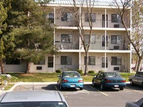 Eagle apartment for rent - three cars parked in a parking lot in front of an apartment building