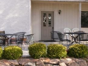 Eagle apartment for rent - a porch with tables and chairs and a white door