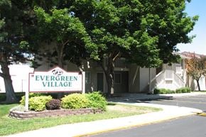 Gooding apartment for rent - a sign for evergreen village in front of a building