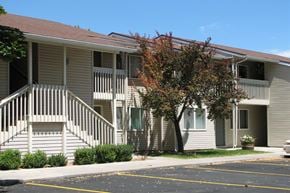 Gooding apartment for rent - a building with stairs and a tree in front of it