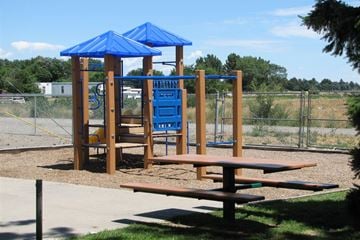 Gooding apartment for rent - a playground with a swing set and a picnic table
