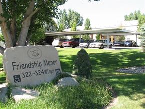 Caldwell apartment for rent - a sign for friendship manor in front of a parking lot