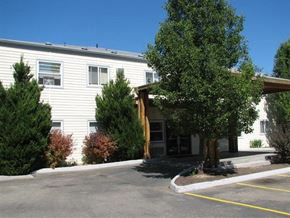 Caldwell apartment for rent - a white building with a tree in front of it