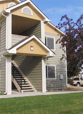 Nampa apartment for rent - a green house with a yellow roof and stairs