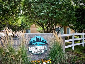 Boise apartment for rent - a sign for geller farms in front of a fence and trees