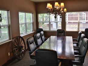 Boise apartment for rent - a dining room with a long wooden table and chairs