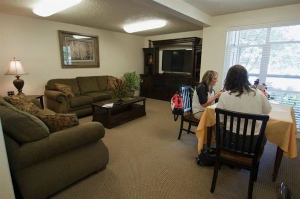 Gooding apartment for rent - two people sitting at a table in a living room