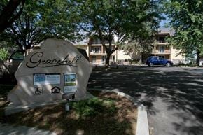 Gooding apartment for rent - a rock sign sitting in the grass next to a street