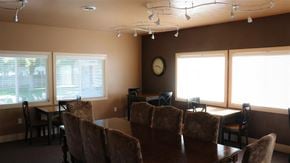 American Falls apartment for rent - a dining room table with chairs and a clock on the wall