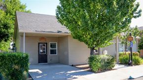 American Falls apartment for rent - a white building with a door and a tree in front of it
