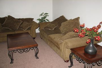 Boise apartment for rent - a living room with couches and a table and flowers